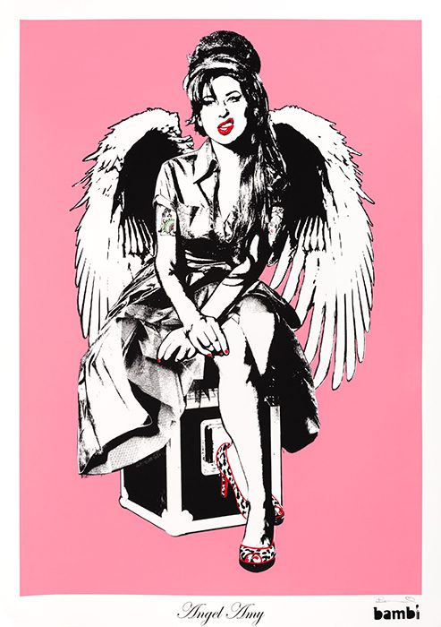 The artwork shows a screenprint by street artist Bambi depicting Amy Winehouse sitting on a box with large, angelic wings. Amy is dressed in a retro-inspired outfit with her iconic beehive hairstyle and red lips, set against a bright pink background. The monochromatic figure contrasts with the vibrant backdrop, making the piece visually striking. Below the image, the title "Angel Amy" is written in script, along with the artist's signature "bambi" in the lower right corner.