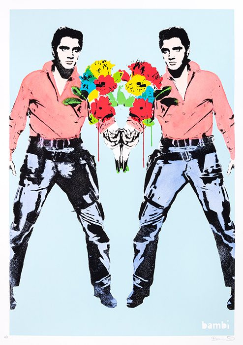 The artwork by street artist Bambi features a mirrored image of Elvis Presley in his classic pose, wearing a red shirt and black pants. Both versions of Elvis are facing inward, standing side by side with vibrant, colorful bouquets of flowers between them. The flowers are painted in bold hues of red, yellow, green, and blue, with a dripping effect that contrasts with the otherwise clean image of Elvis. The background is light blue, making the figures and flowers stand out. The artist's name "bambi" is signed in the lower right corner.